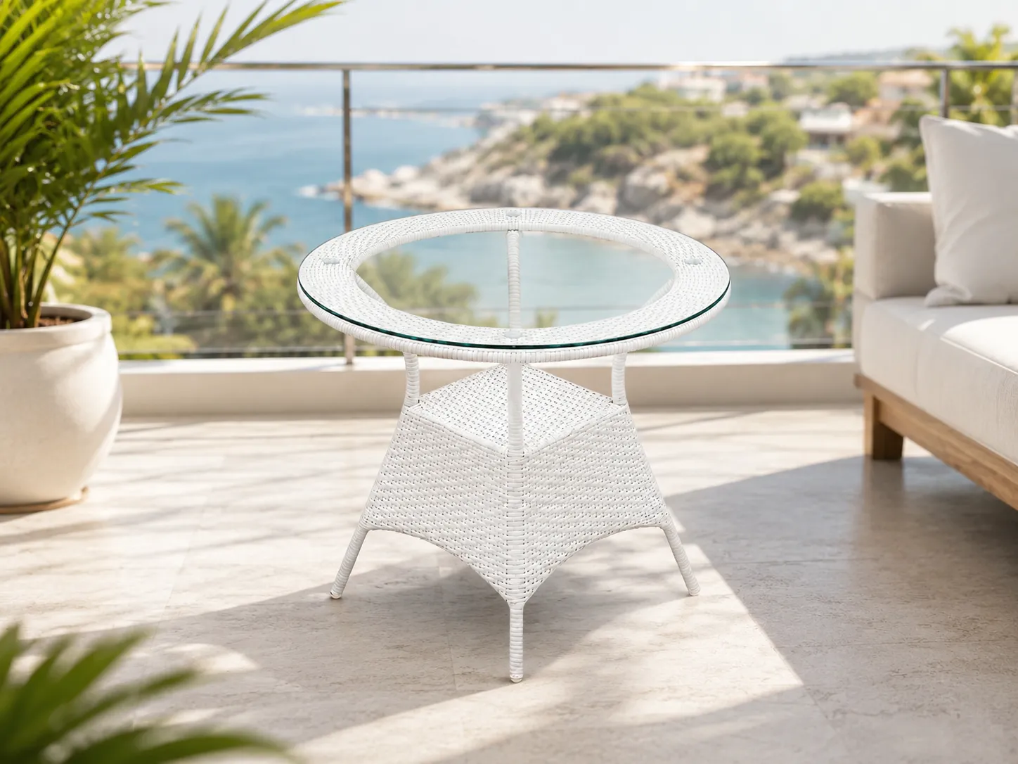 White wicker round glass table used on a balcony outdoor seating area
