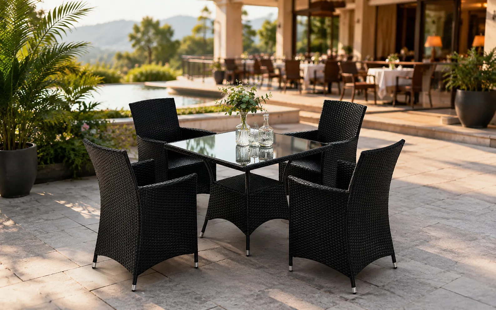 Black PE rattan patio dining set with 4 armchairs and square glass table