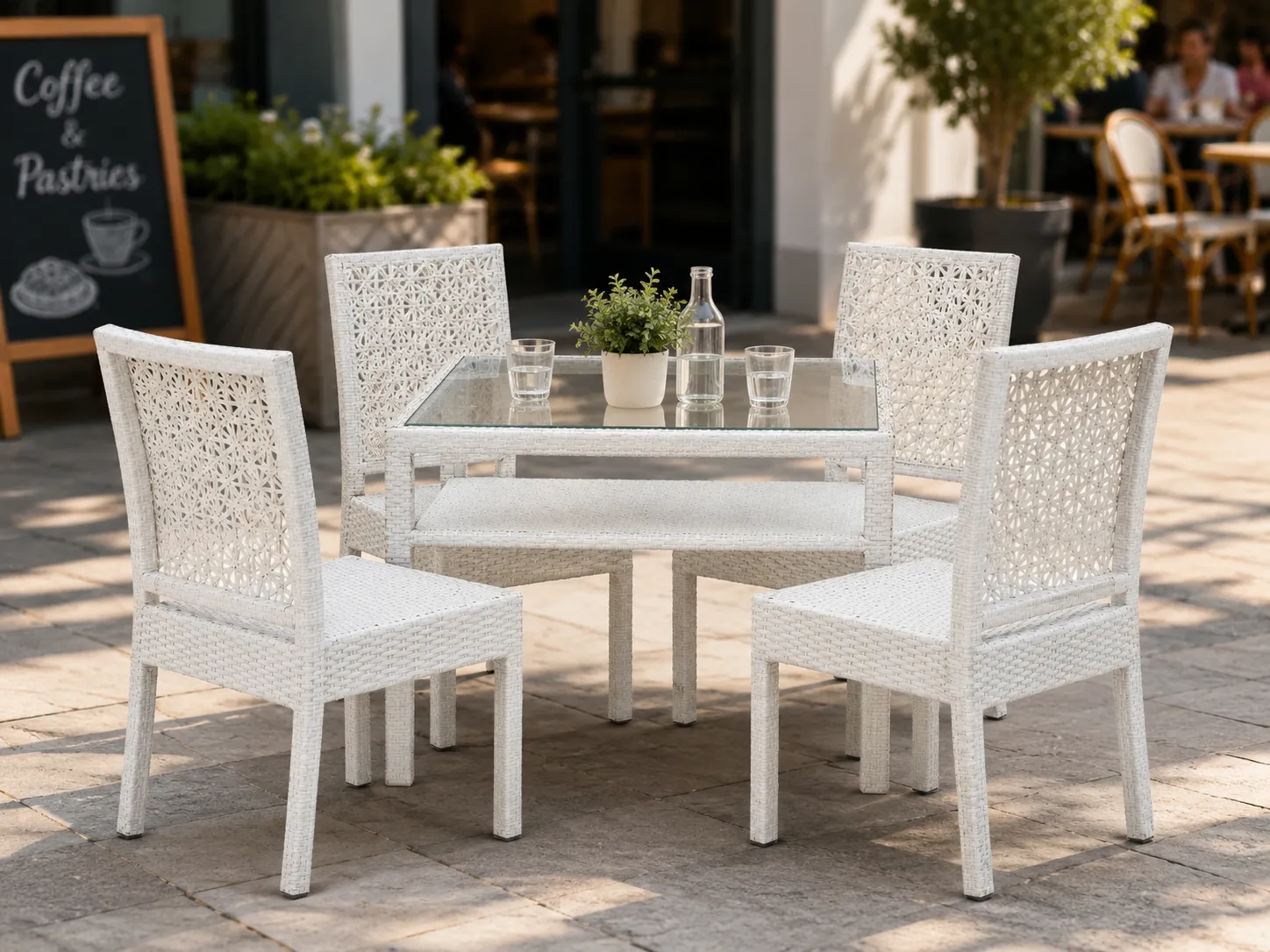 White rattan dining table and chairs for café terrace