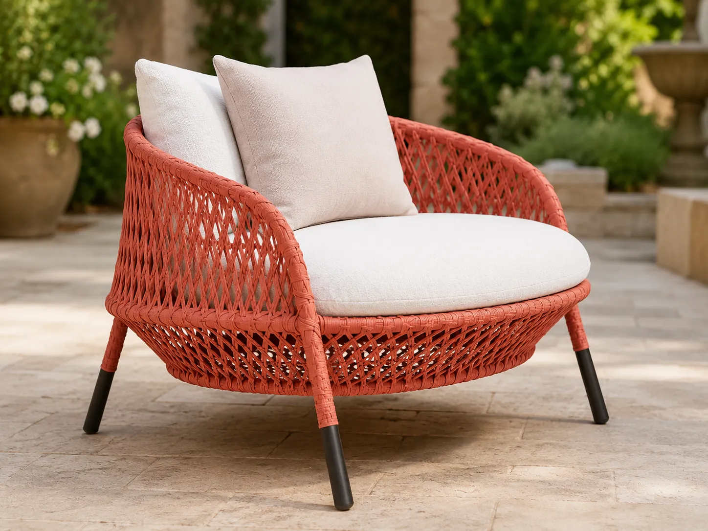 Coral wicker lounge chair detail with cream cushion and woven frame