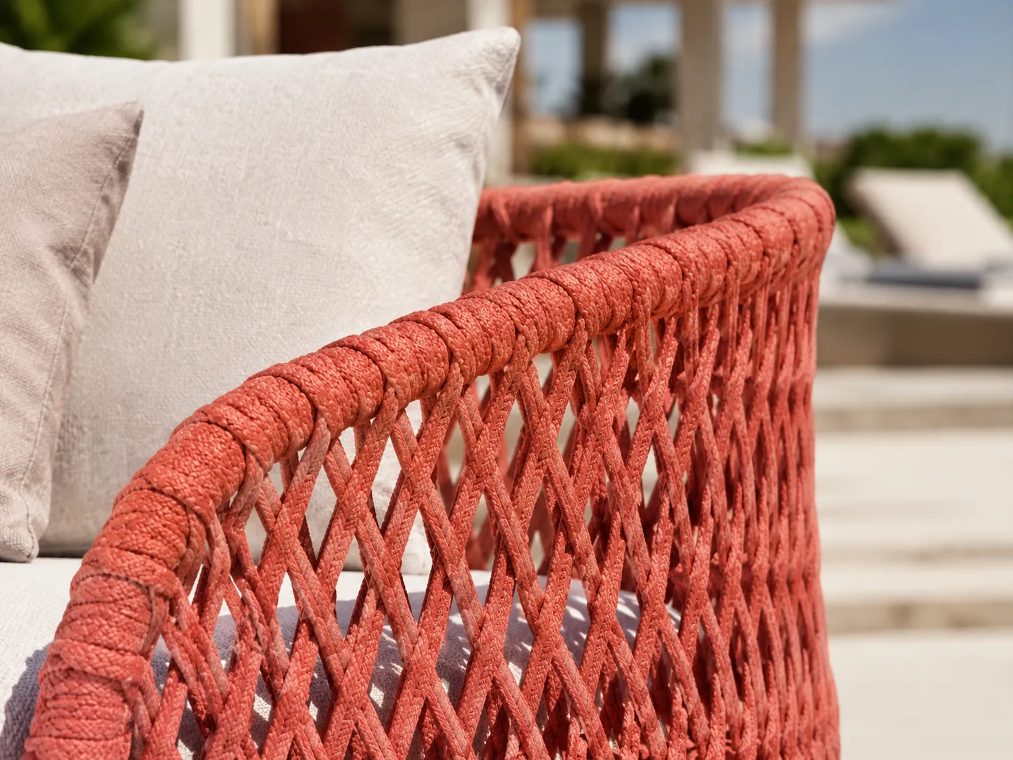 Close-up detail of coral woven wicker frame for outdoor sofa set