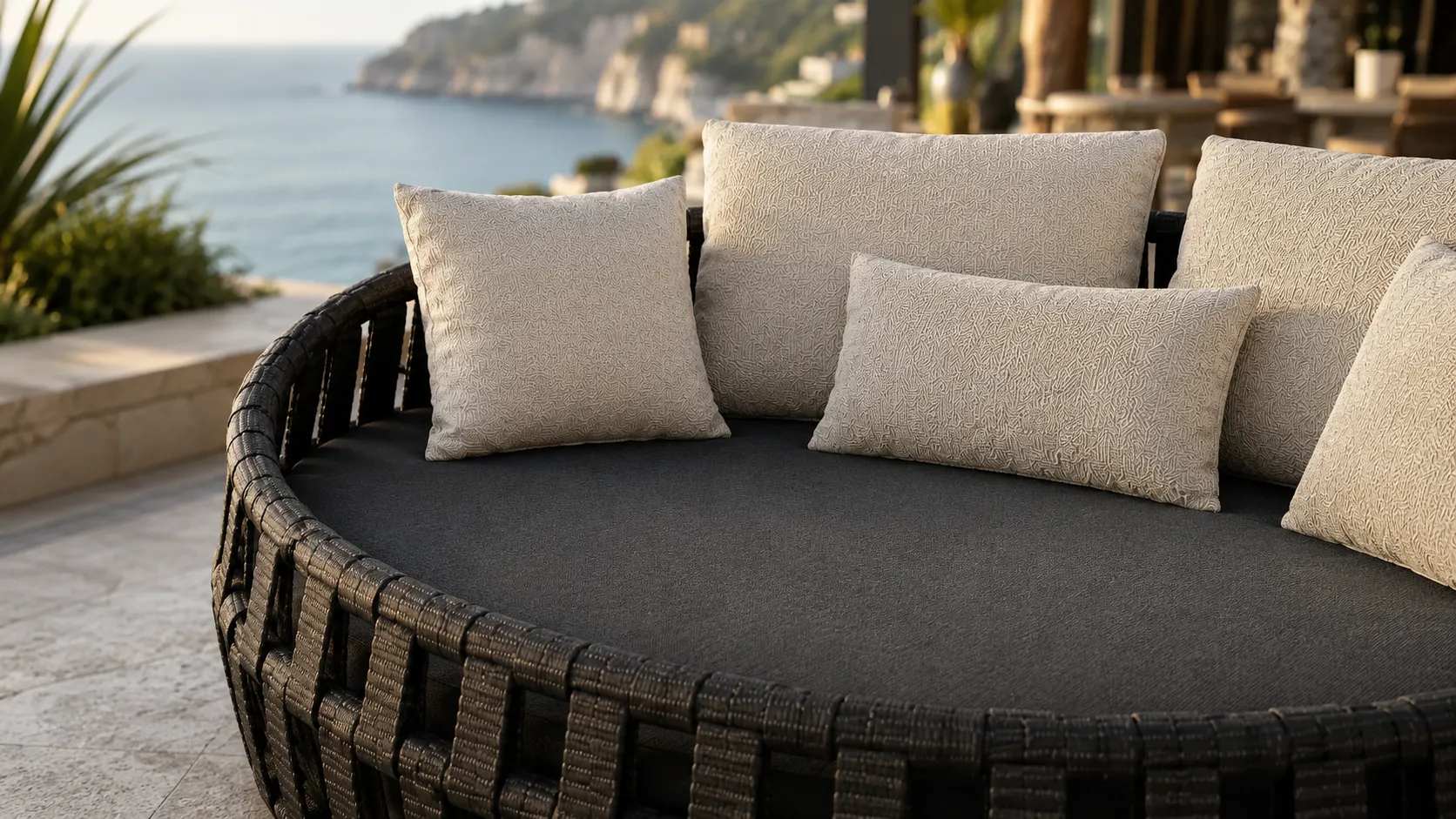 Cream cushion and dark seat detail for black wicker outdoor daybed