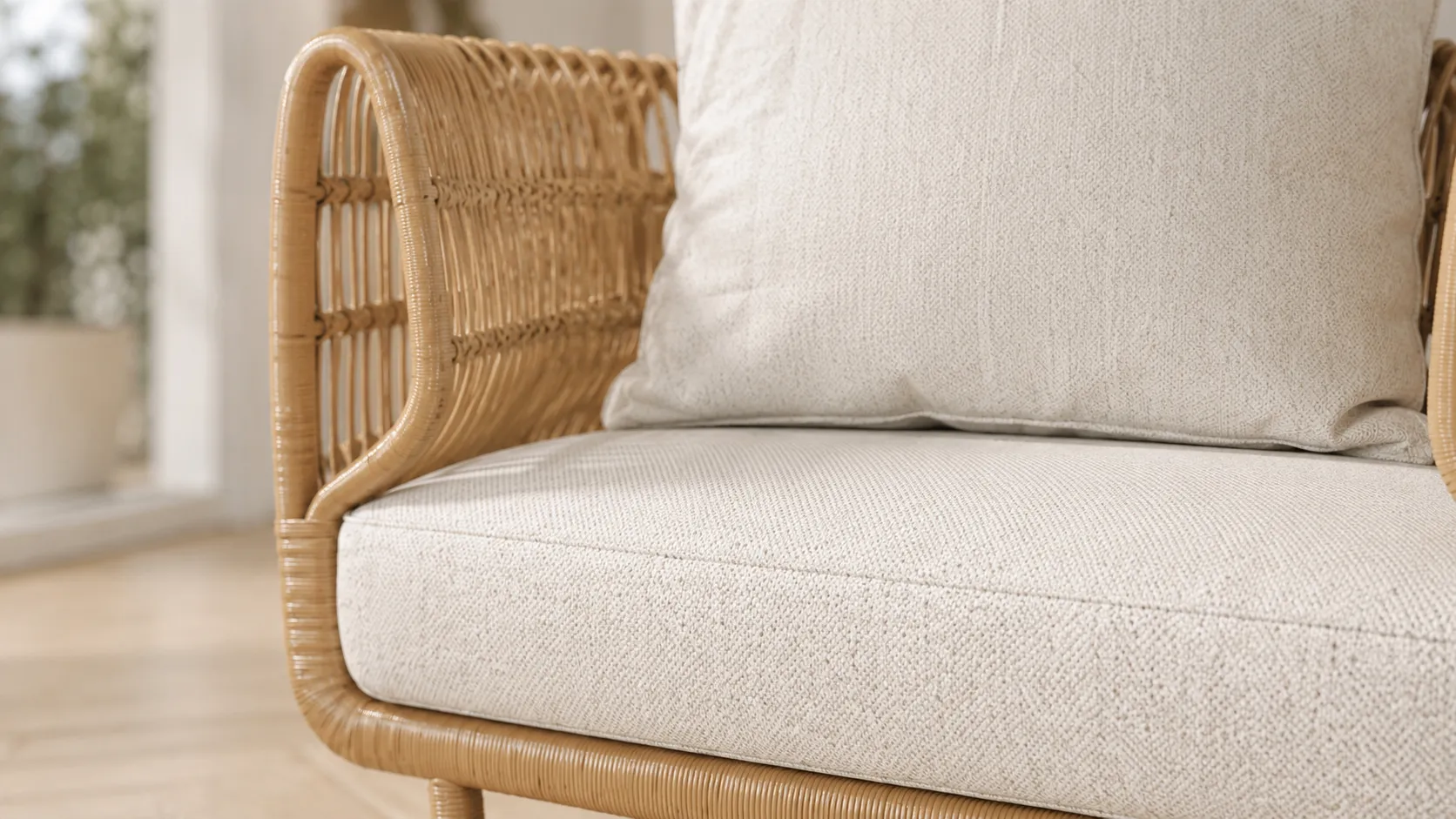 Cream cushion detail for natural rattan outdoor lounge chair