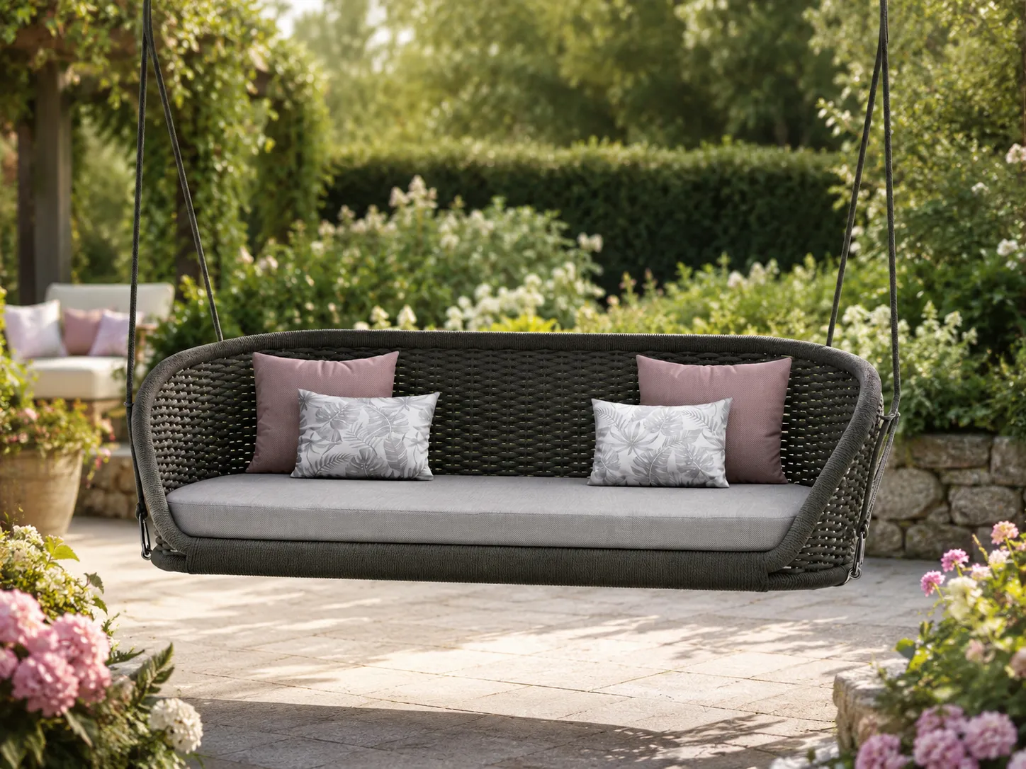 Rope hanging swing sofa used in an outdoor garden lounge area