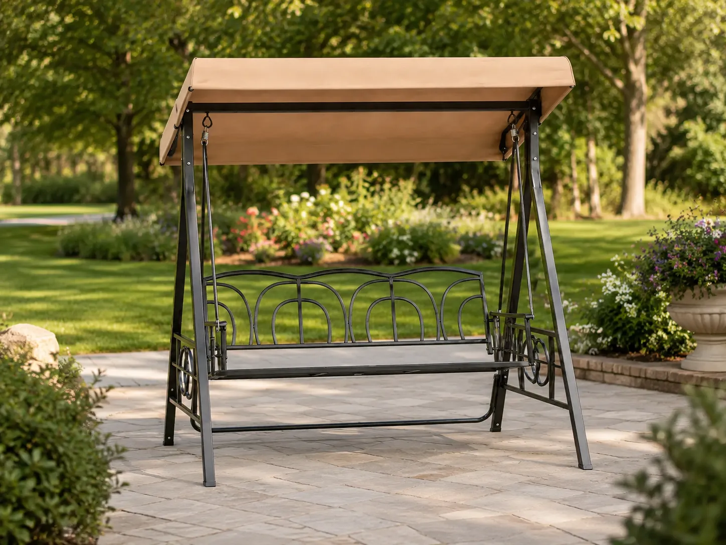 Three-seater outdoor swing chair used in a garden leisure area