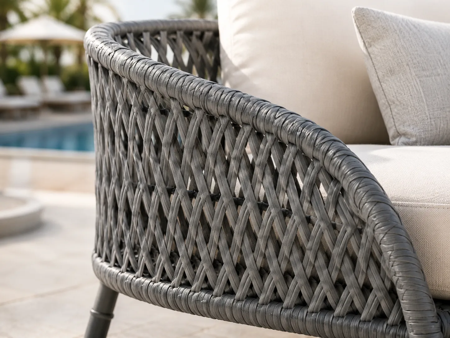 Close-up detail of grey woven wicker frame for outdoor sofa set