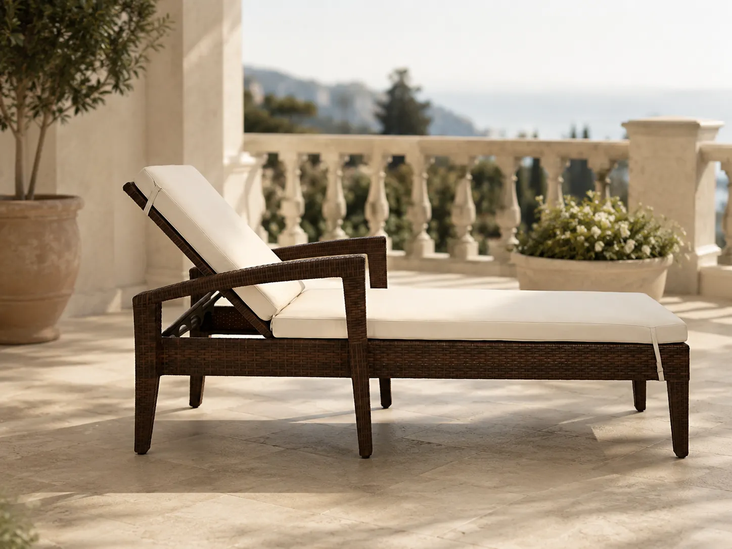 Wicker sun lounger with armrests for hotel balcony leisure areas