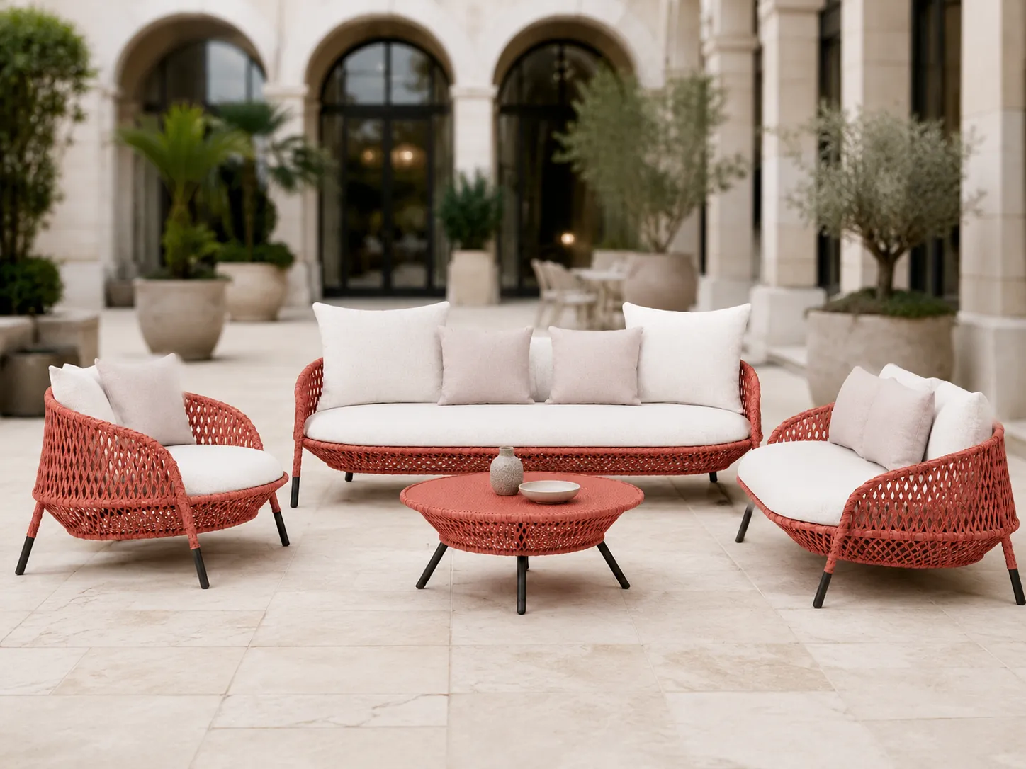 Coral wicker outdoor conversation set used in a hotel courtyard lounge area