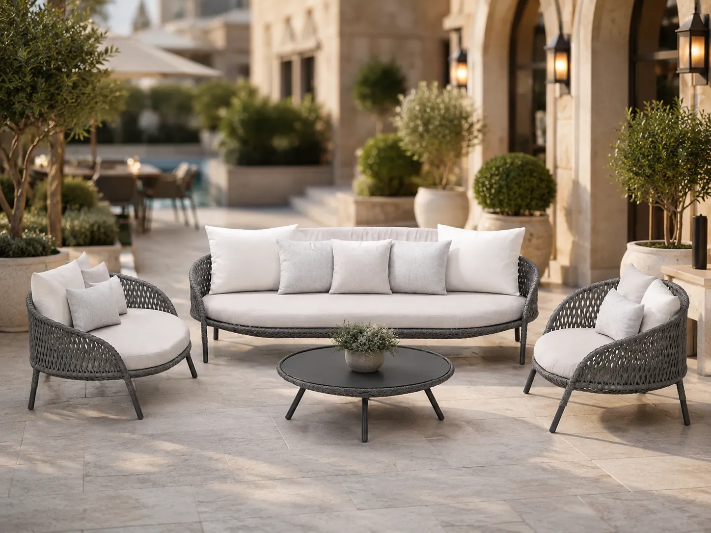 Grey wicker outdoor conversation set used in a hotel courtyard lounge area