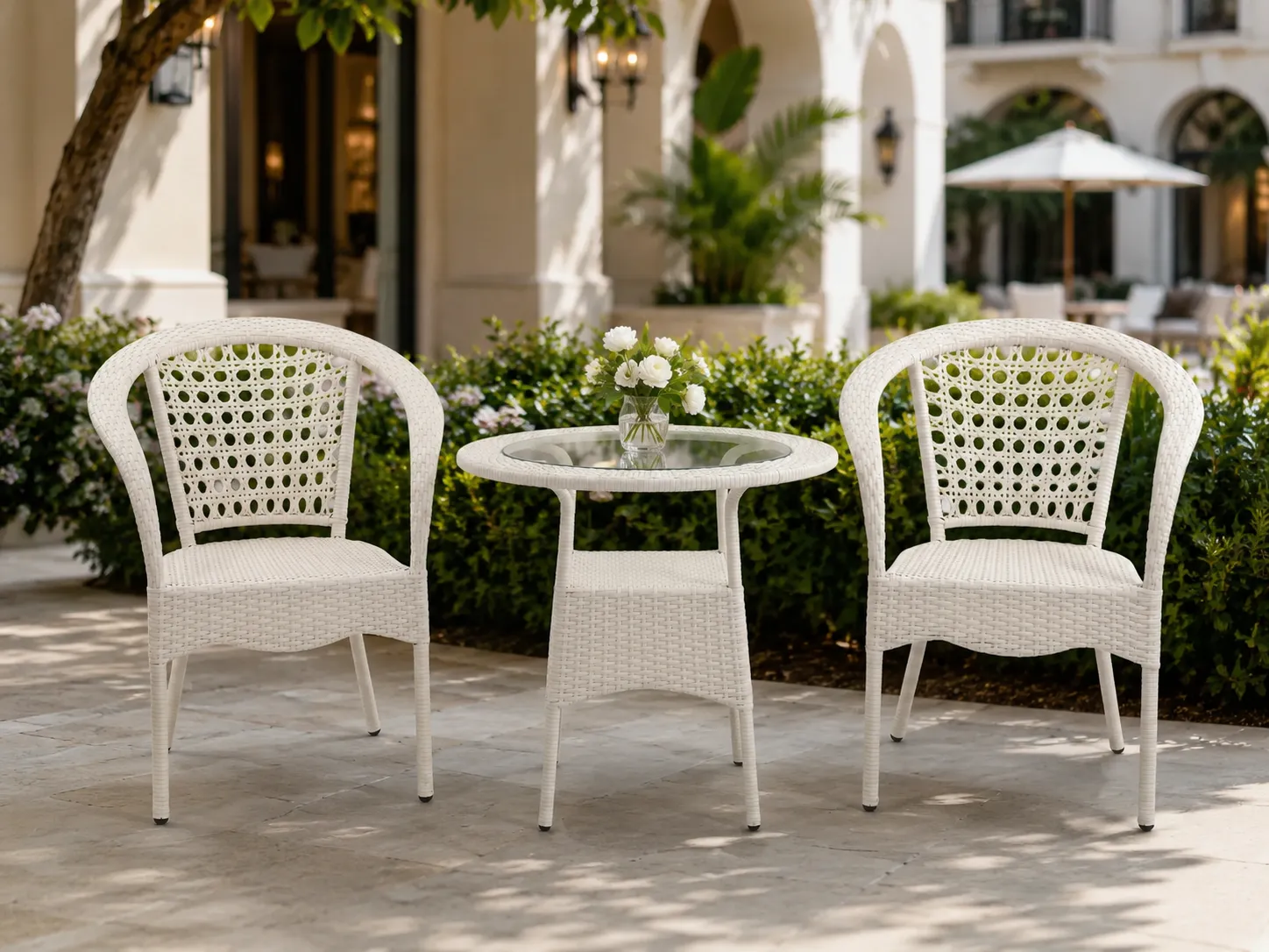 White wicker bistro set for hotel courtyard