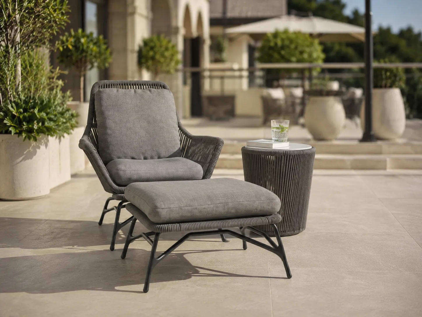 Outdoor rope lounge chair and ottoman set for hotel terrace
