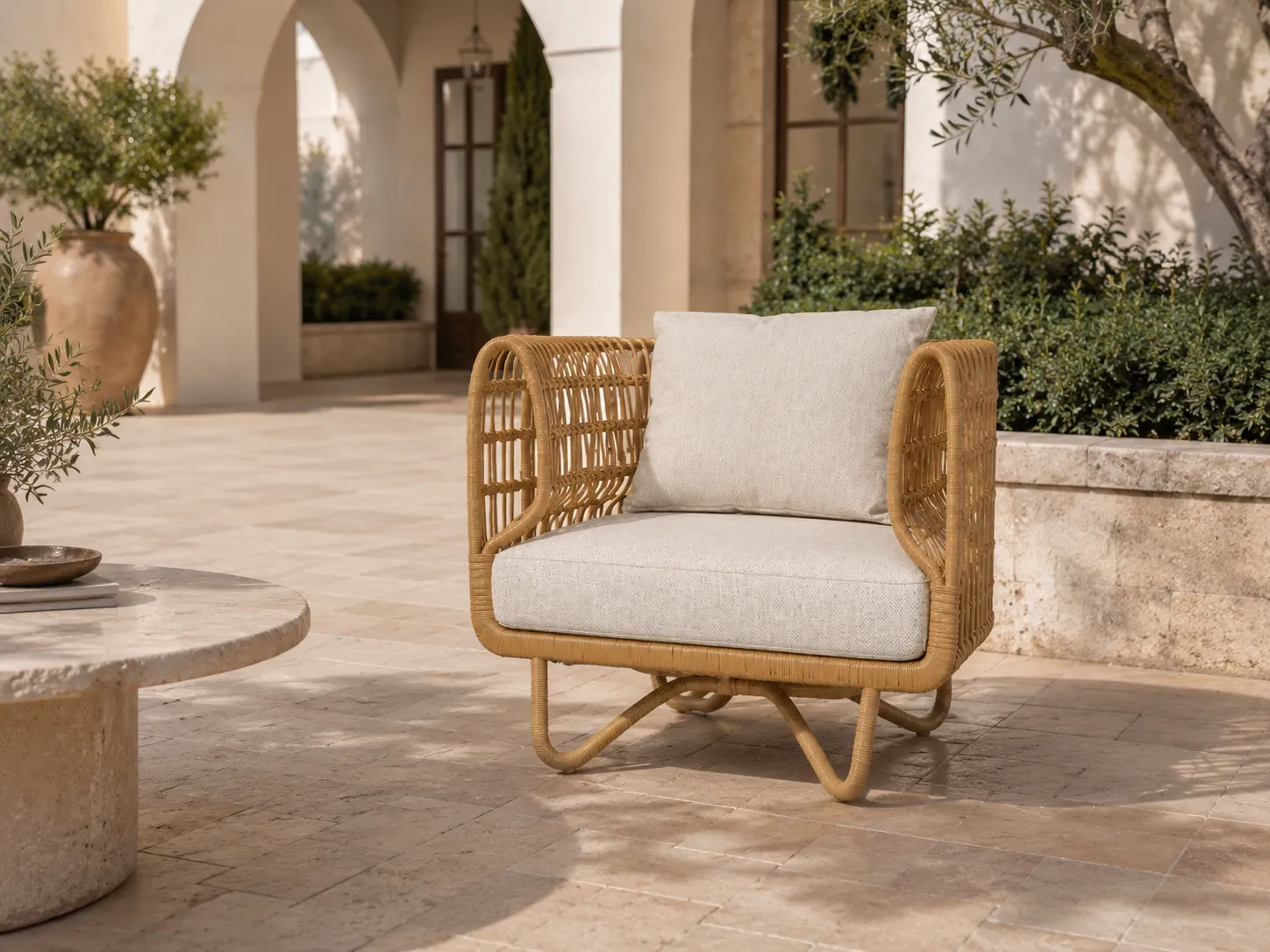 Side view of natural rattan outdoor lounge chair with rounded armrests