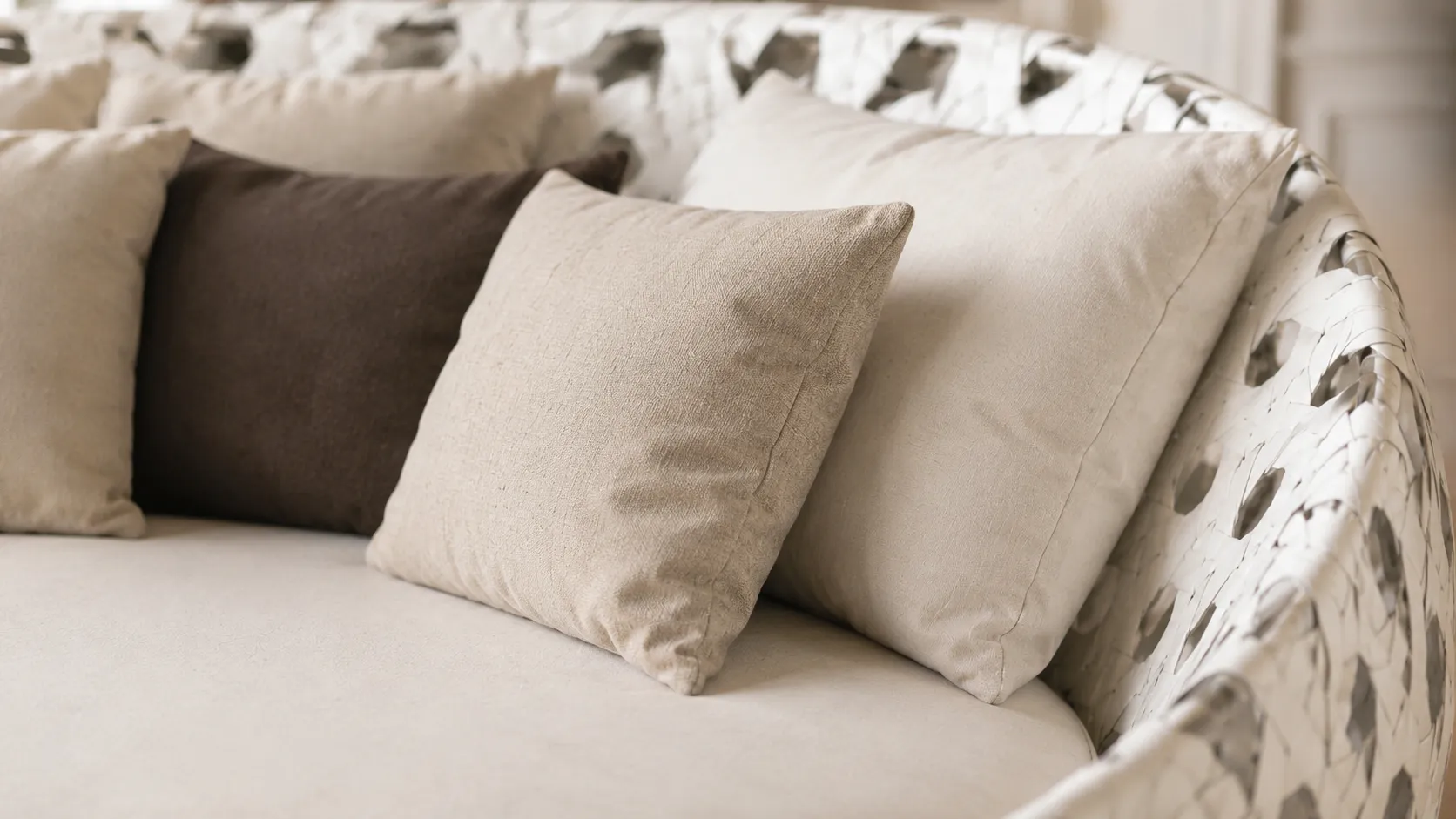 Neutral cushion detail for white round wicker outdoor daybed