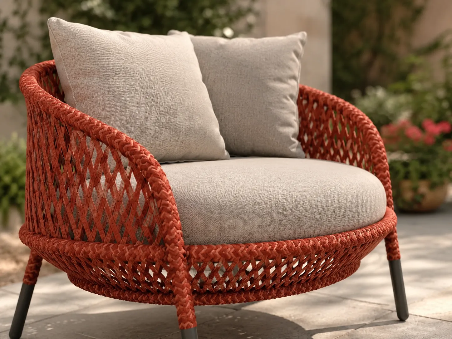 Orange wicker lounge chair detail with grey cushion and woven frame