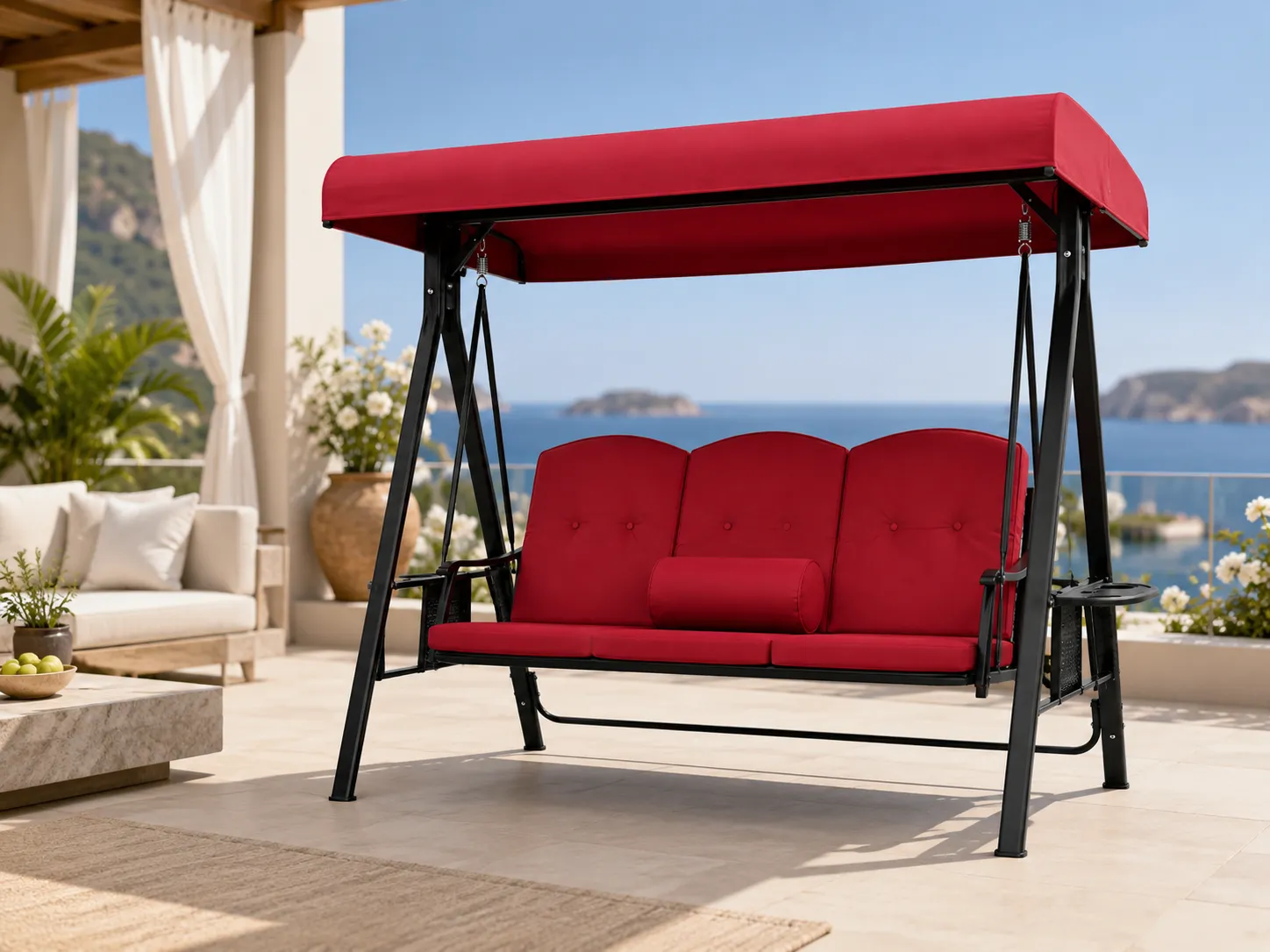 Steel canopy swing sofa with red cushions used in an outdoor patio seating area