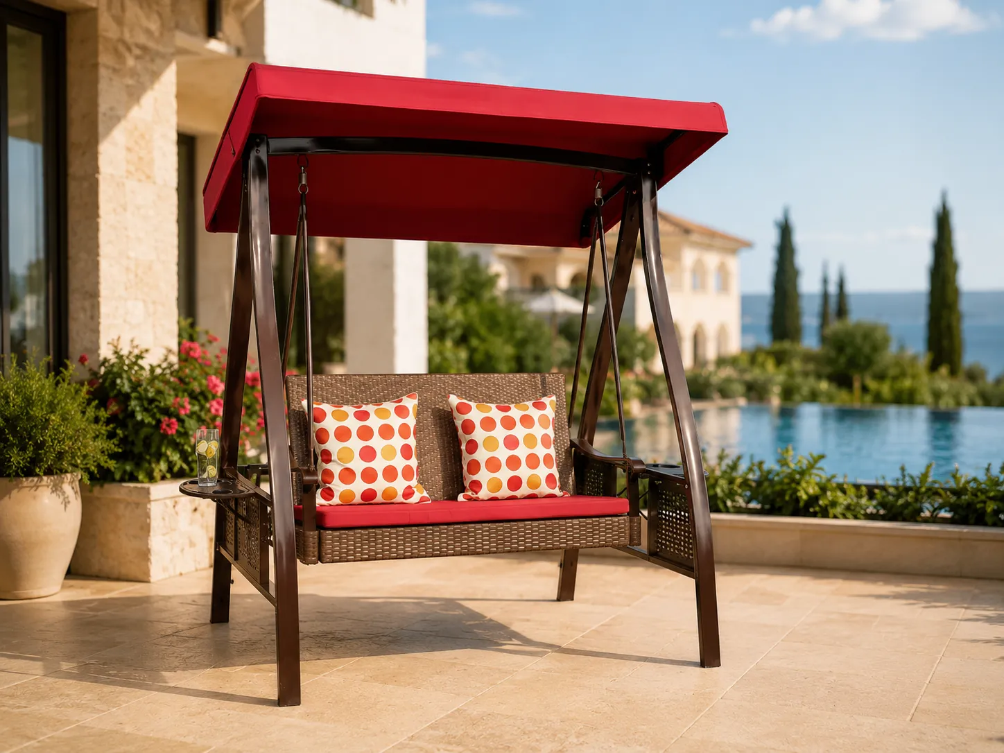 Wicker canopy swing chair with red cushions for patio seating