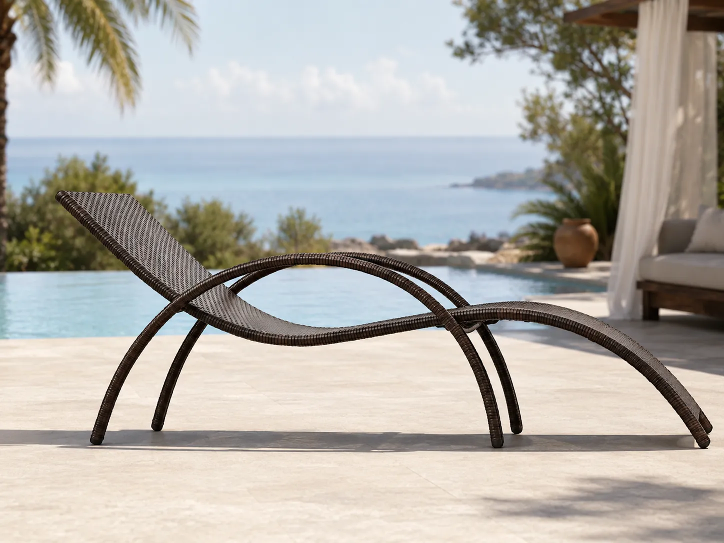 Side view of PE rattan outdoor sun lounger with curved chaise profile