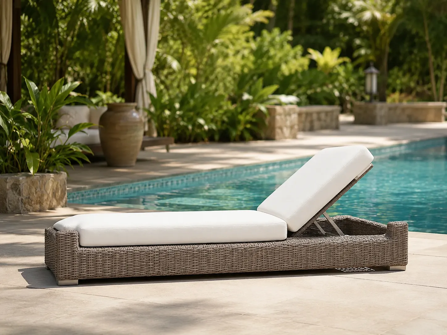Adjustable wicker outdoor sun lounger used beside a resort swimming pool