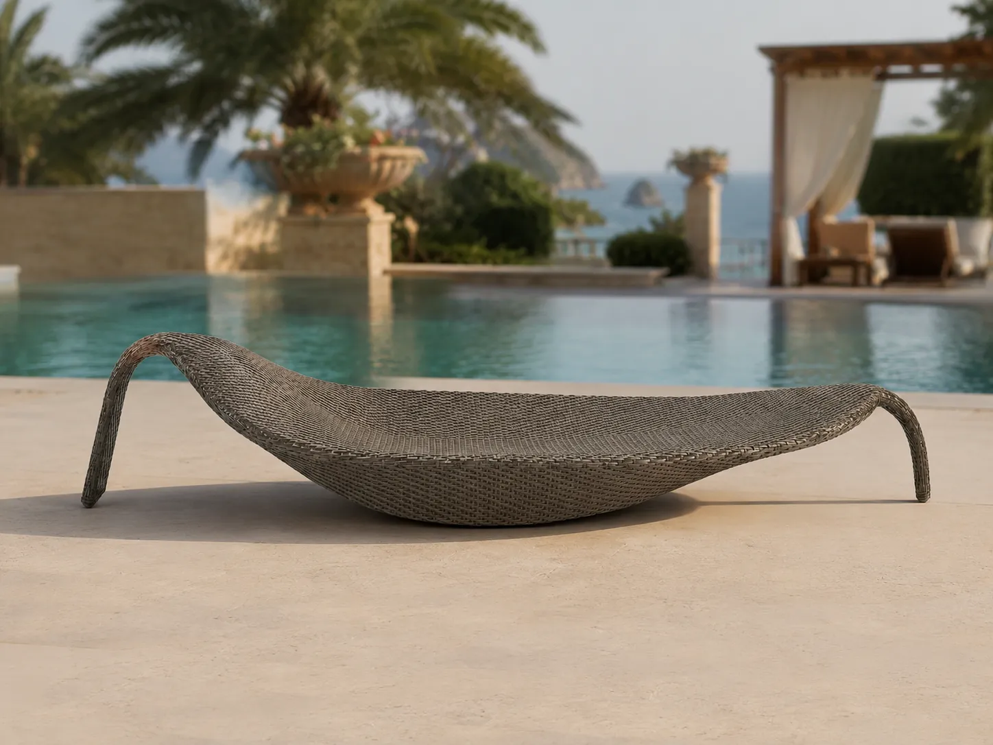 Curved wicker outdoor sun lounger used beside a resort pool