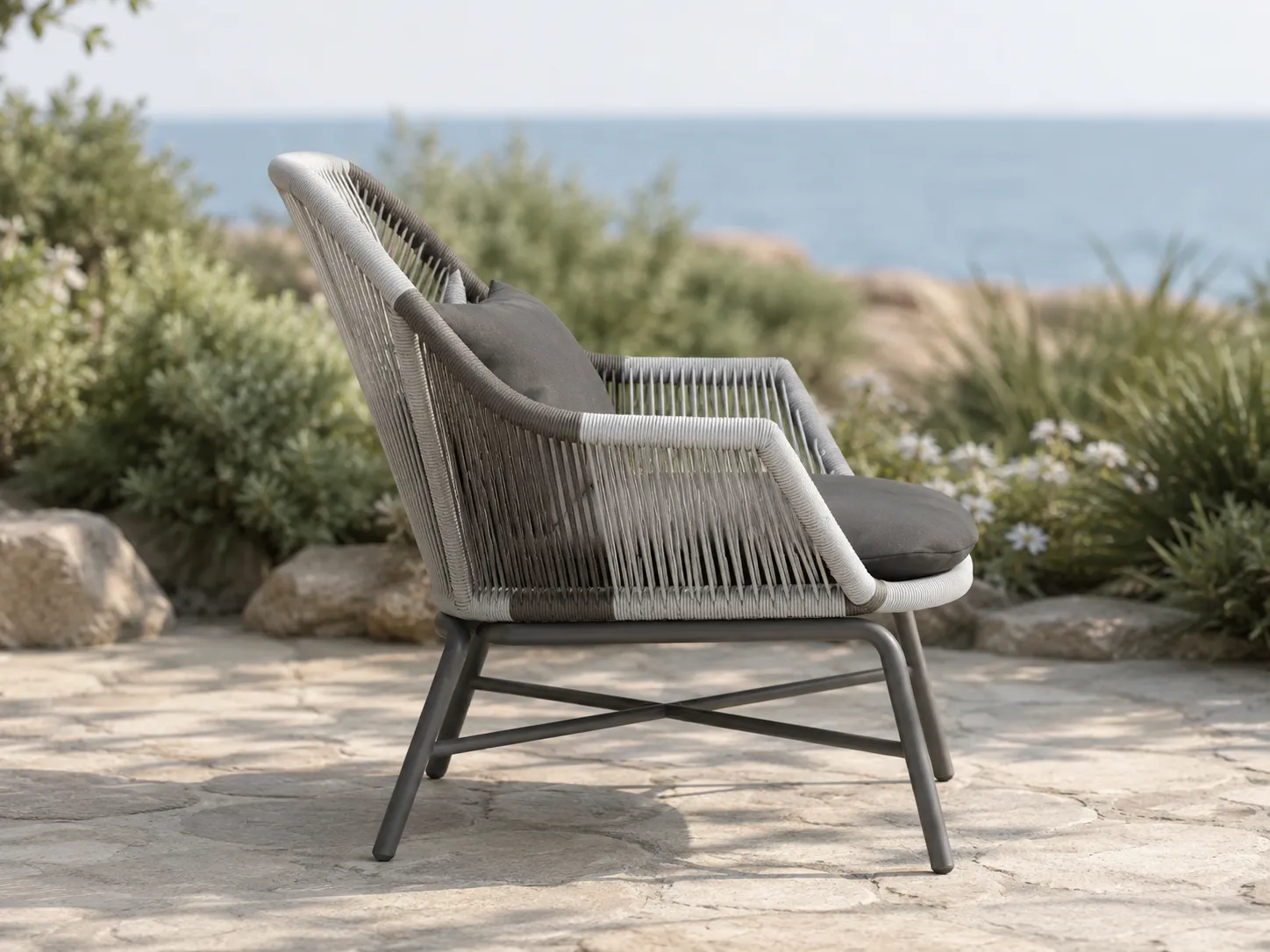 Side view of woven rope outdoor lounge chair with dark cushion