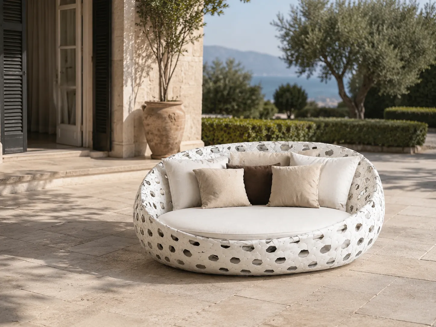 Side view of white round wicker outdoor daybed for hospitality furniture projects