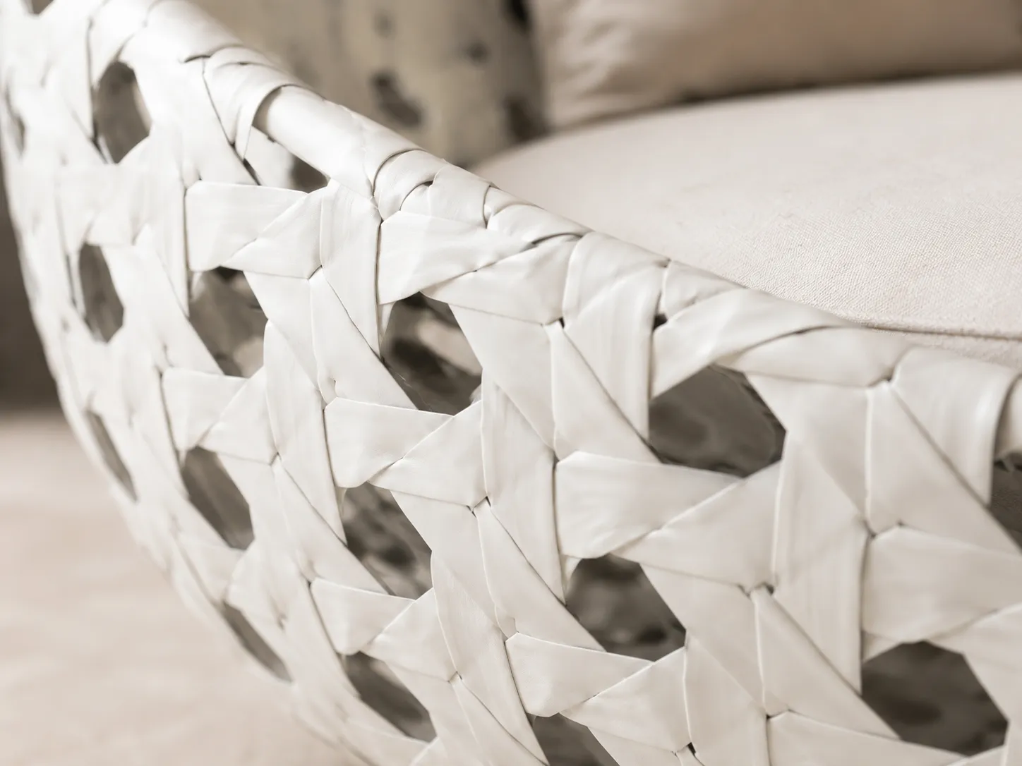 Close-up detail of white woven wicker frame for round outdoor daybed