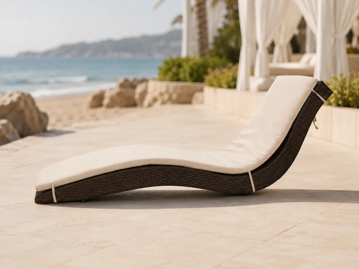 Side view of adjustable wicker outdoor sun lounger with beige cushion