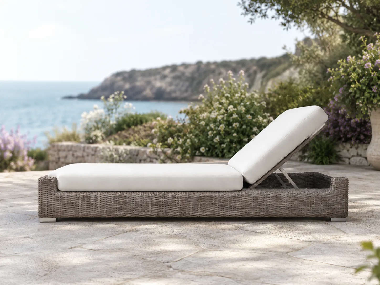 Side view of wicker outdoor sun lounger with white cushion and adjustable backrest